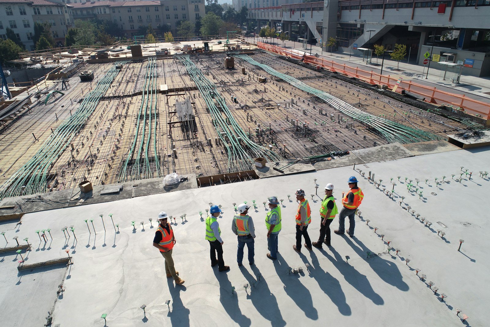 Construction site with crews reviewing work in progress